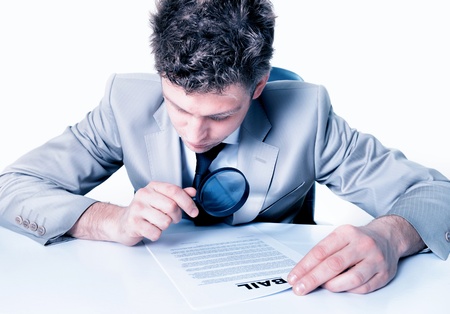 handsome Businessman with magnifying glass analyze contractの写真素材