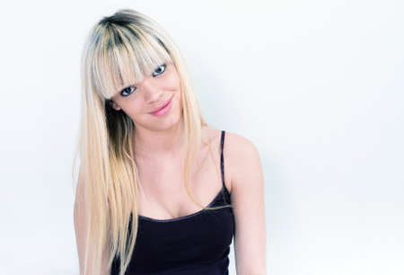 Portrait of a cute young female smiling over white backgrounの写真素材