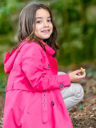 portrait of little girl with a cake in handの写真素材