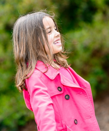 Portrait of happy cute child standing in a parkの写真素材