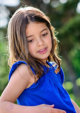 beautiful portrait of cute child with greenery in the backgroundの写真素材