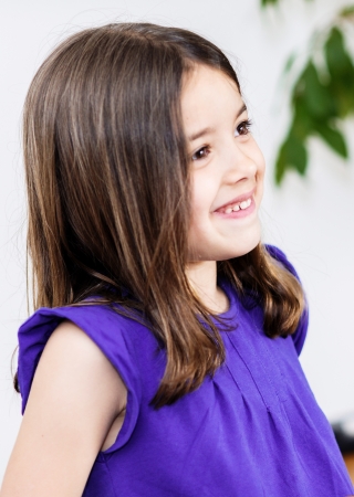 Expressive portrait of very cute girl smiling childの写真素材