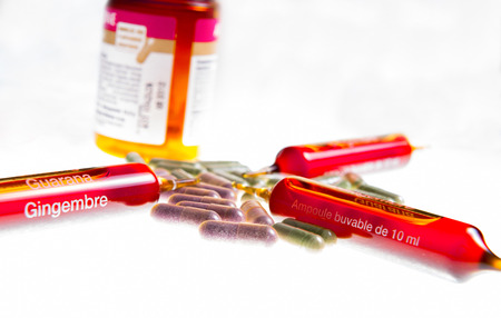 Close up of vitamin ampuls and natural pillsの写真素材