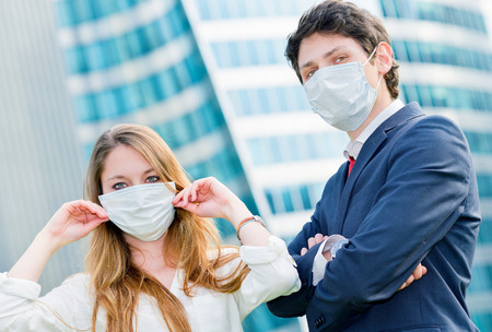 Junior executives dynamics  wearing protective face mask against pollutionの写真素材