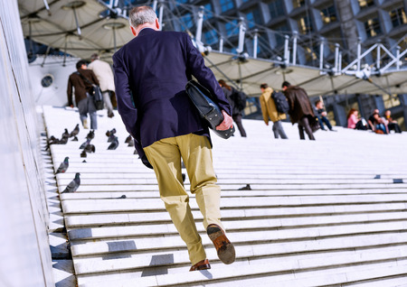 Back view of  rush hour, city workers going to workの写真素材