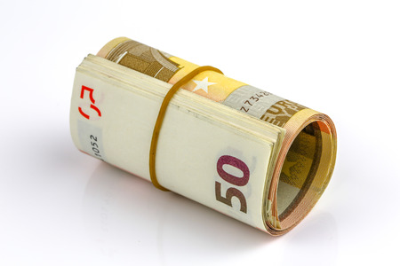 Roll of one Fifty euro banknotes with a rubber band, isolated on the white background, clipping path included. Full focus.の写真素材