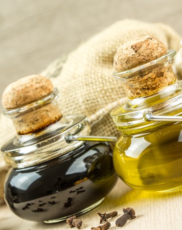 Olive oil and vinegar in bottles on old wooden table with thyme, onion, herbs provencesの写真素材