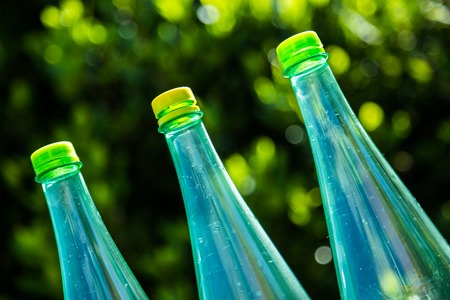 Closeup of bottles isolated on nature backgroundの写真素材