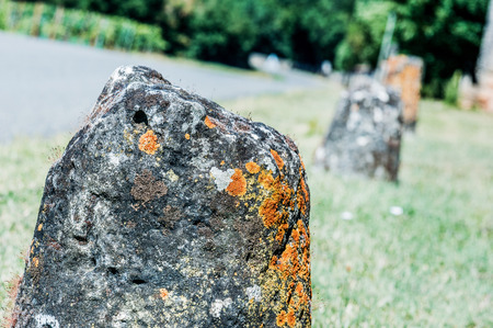 Old Ruined Stones in a row one the side of the roadの写真素材