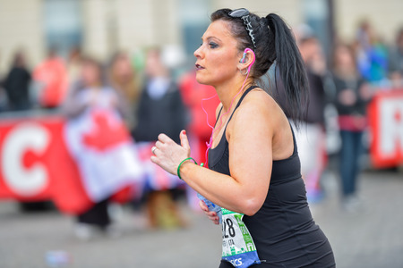 PARIS, FRANCE - APRIL 06: girl isolated at Paris International Marathon on April 06, 2014 in Paris, Franceのeditorial素材