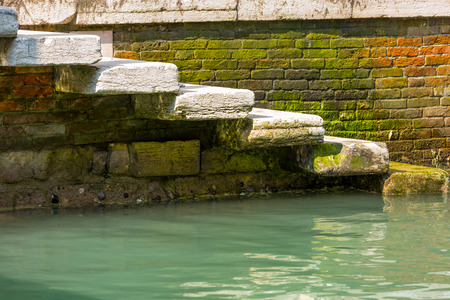 Closeup on staircase in narrow canal in center of Venice.の写真素材