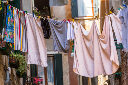 Venetian windows with the laundry drying on a wireの写真素材