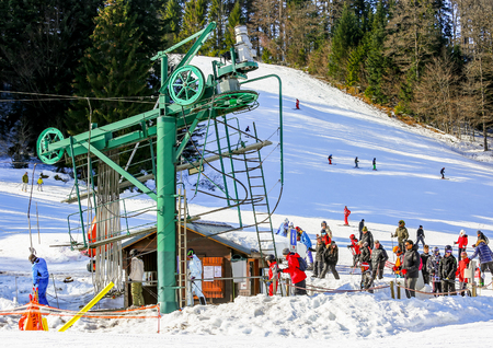GERARDMER, FRANCE - FEB 19 - Group of skiers standing in line in front of ski lift during the annual winter school holiday on Feb 19, 2015 in Gerardmer, Franceのeditorial素材