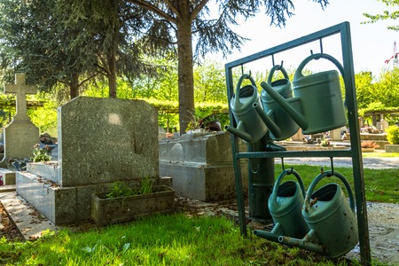 Close up of watering cans used to water the plants Cemeteryの写真素材
