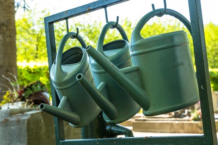 Close up of watering cans used to water the plants Cemeteryの写真素材