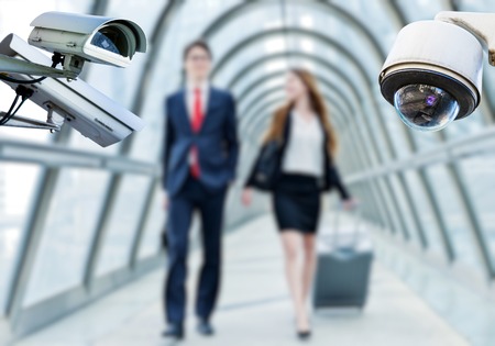 security CCTV camera or surveillance system with airport area and people on blurry backgroundの写真素材
