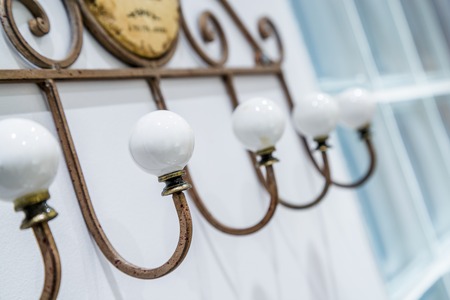 old row vintage coat rack with a porcelain ballの写真素材