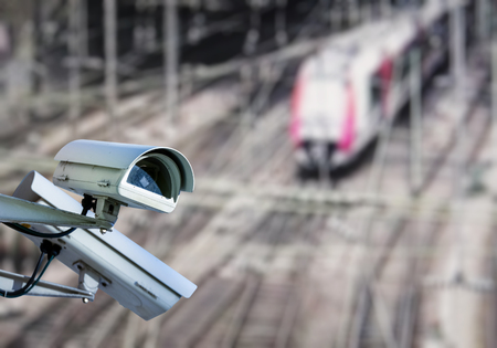 security CCTV camera or surveillance system with train station on blurry backgroundの写真素材
