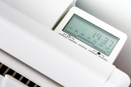 High angle closeup of modern radiator with digital timer High angle closeup of modern radiator with digital timer