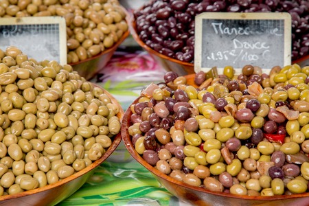 Provencal Mix of Olives ("Melange Provencal" in French) ) in wooden bowl at the food market in Parisの写真素材