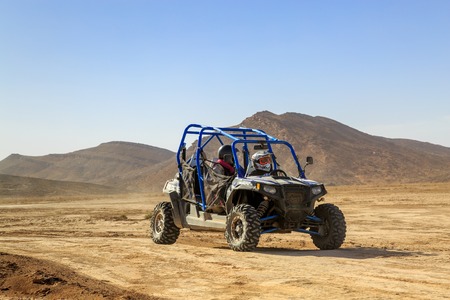 Merzouga, Morocco - Feb 24, 2016: Blue Polaris RZR 800 and pilots in Morocco desert near Merzouga. Merzouga is a small village located in the Saharan south-eastern Morocco. Merzouga is famous for its dunes, the highest in Morocco.のeditorial素材