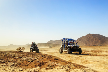 Merzouga, Morocco - Feb 24, 2016: convoy of off-road vehicles (RZR, Quad and motorbikes) in Morocco desert near Merzouga. Merzouga is famous for its dunes, the highest in Morocco.のeditorial素材
