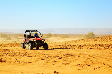 Merzouga, Morocco - Feb 22, 2016: front view on blue Polaris RZR 800 with it's pilots in Morocco desert near Merzouga. Merzouga is famous for its dunes, the highest in Morocco.のeditorial素材