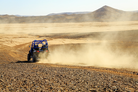 Merzouga, Morocco - Feb 25, 2016: back view on blue Polaris RZR 800 with it's pilot in Morocco desert near Merzouga. Merzouga is famous for its dunes, the highest in Morocco.のeditorial素材