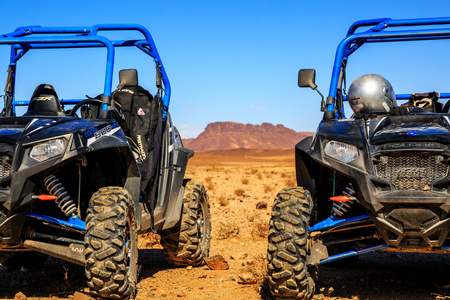 Merzouga, Morocco - Feb 21, 2016: blue Polaris RZR 800 aligned and stationed with no pilot in Morocco desert near Merzouga. There is a great mountain in the backgroundのeditorial素材