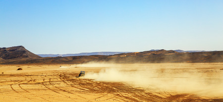 panoramic view on convoys of off road cars with in Morocco desert near Merzougaの写真素材