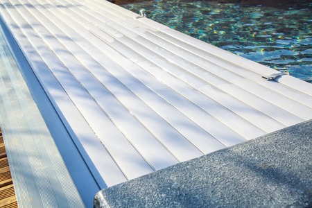 closeup on swimming pool roller-shutter covers