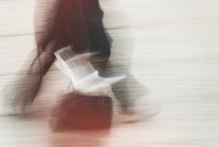 blurry to view of man walking in a streetの写真素材