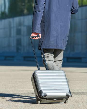 La defense, France- April 10, 2014: Business traveler walking down the street and pulling suitcaseのeditorial素材