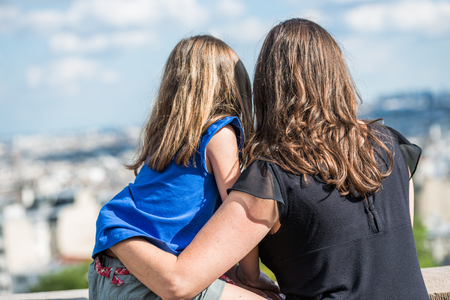 Paris, France- June 30, 2013: mother and daughter hugging in love watching paris from the top of the montmartre hillのeditorial素材