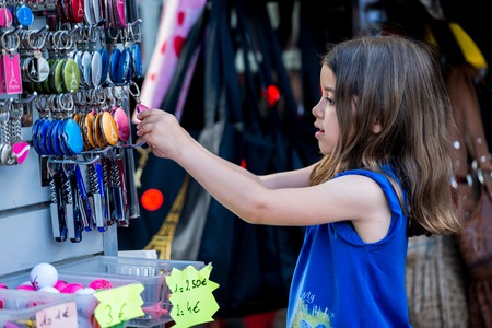 Paris, France- June 30, 2013:Kid choose a tipical souvenir of Paris in a shop near Montmartre, the...