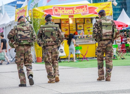 La defense, France - July 17 2016: French military patrol assigned to the surveillance of a business district near Paris. These troops ensure the safety of the citizens and are there in prevention of the terrorist attacks perpetrated in Franceのeditorial素材