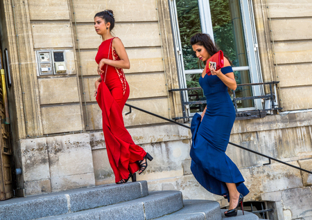 Houilles France - July 16, 2016:Two beautiful bridesmaids climbing the steps of the town hall before the wedding celebrationのeditorial素材