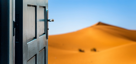 Opened door concept to beautiful and imaginary desert landscapeの写真素材