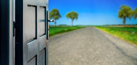Opened door concept to beautiful road contryside landscapeの写真素材