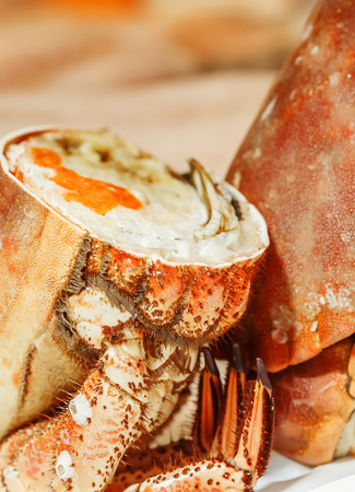 half of fresh crab on ice for sale in a fish marketの写真素材