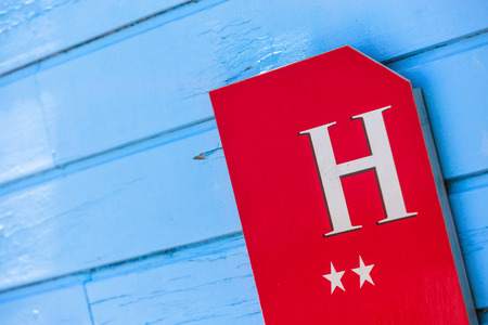 coloreful hotel sign on wooden wallの写真素材