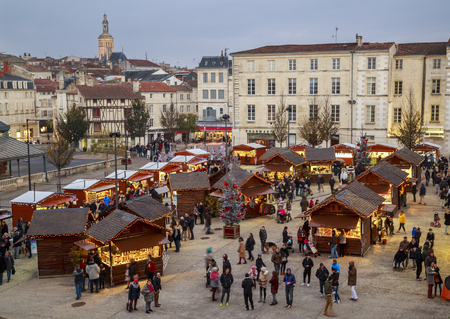 Niort, France - December 03, 2017: Panoramic view of christmas market at night during the festive period vendors sell from temporary wooden chalets in the city centre of Niort town.のeditorial素材