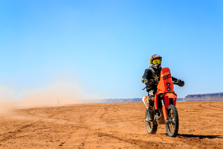Ait Saoun, Morocco - February 22, 2016: Unidentified man in helmet riding bike in Ait Saoun desert of Morocco.のeditorial素材