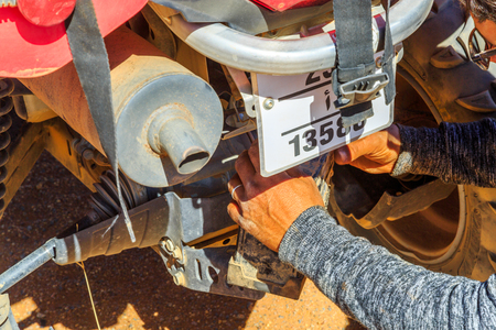 Ait Saoun, Morocco - February 23, 2016: Close-up of human hand changing battery of desert bike atv RZR 800 in desert Ait Saoun in Morocco.のeditorial素材