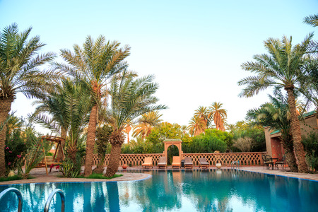 M'hamid, Morocco - February 22, 2016: panoramic view of pool in Chez le Pacha hotel with typical decoration and palm tree aroundのeditorial素材