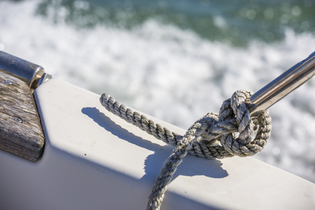 Marine blue rope tied to steel rod on boatの写真素材