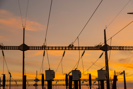 High voltage wire electrical energy plant producing electricity at sunset