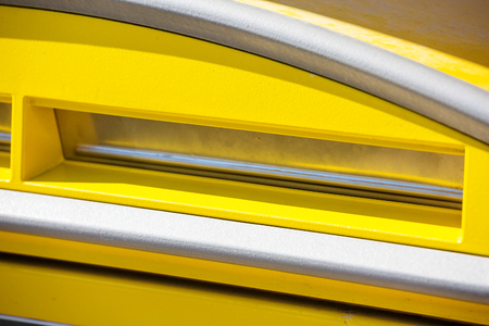 Close-up of a yellow post office on sunny dayの写真素材