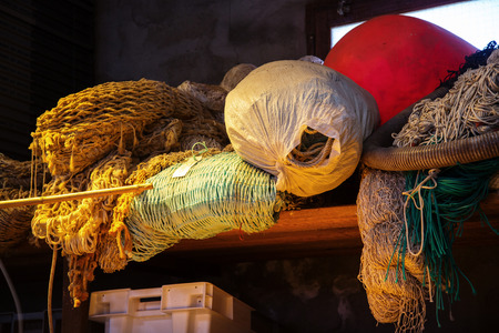 close-up of old fishing nets and other accessories of a fishermanの写真素材