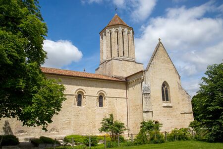 Exterior view of a Catholic Church with back garden and treesの写真素材